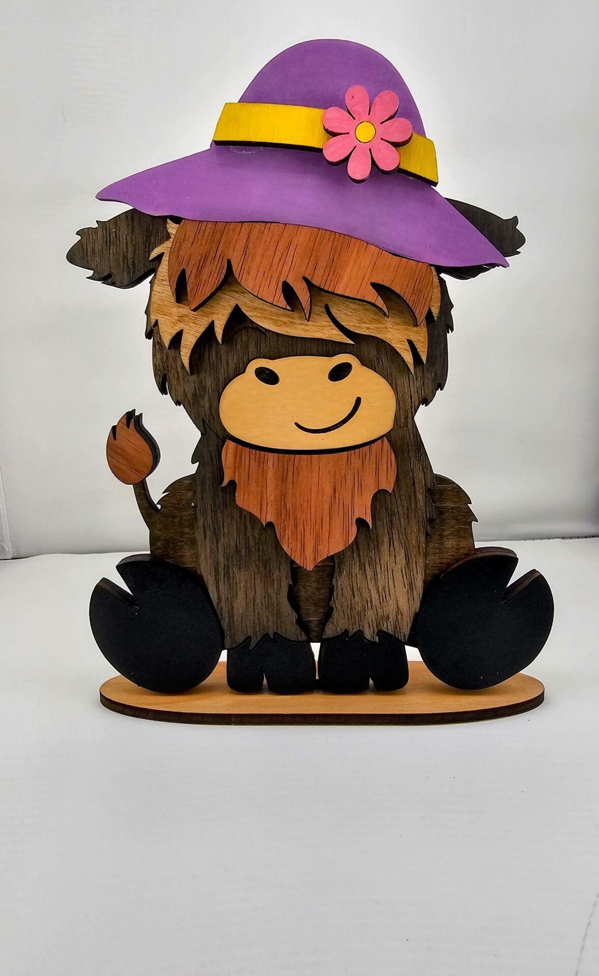 Highland cow wearing spring time hat