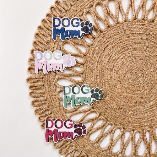 Handmade water-resistant stickers in 4 different color options that feature “Dog Mom” and a paw print