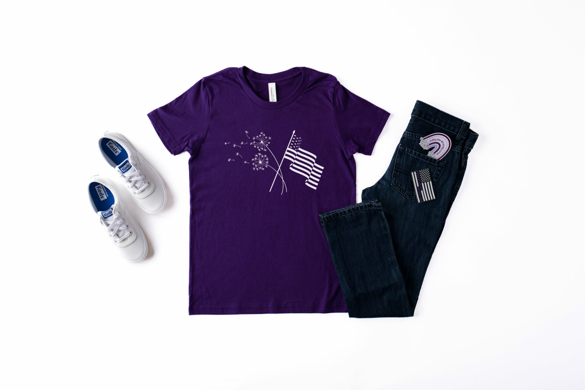 Bella Canvas 3001 T-shirt in Team Purple featuring 2 crossed dandelions with a flag for Month of the Military Child