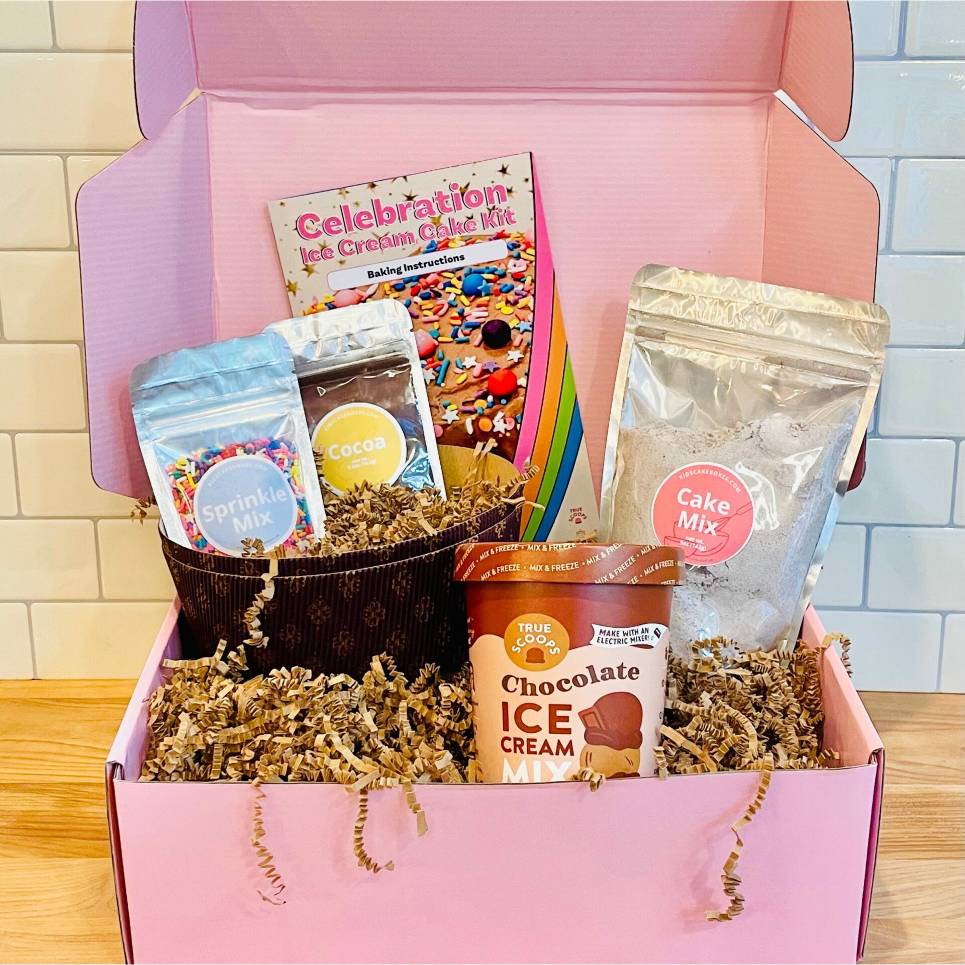 Ice Cream Cake Making Kit from Kids' Cake Boxes includes disposable cake pans, chocolate cake mix, chocolate ice cream mix, cocoa frosting mix, rainbow sprinkles