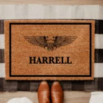 NAVY WSO WINGS WITH CUSTOM LAST NAME CENTERED UNDER IMAGE. BLACK BORDER AROUND EDGE OF DOORMATE. BORDER 1.5 IINCHES ALL THE WAY AROUND ONE INCH BETWEEN EDGE OF MAT AND BORDER